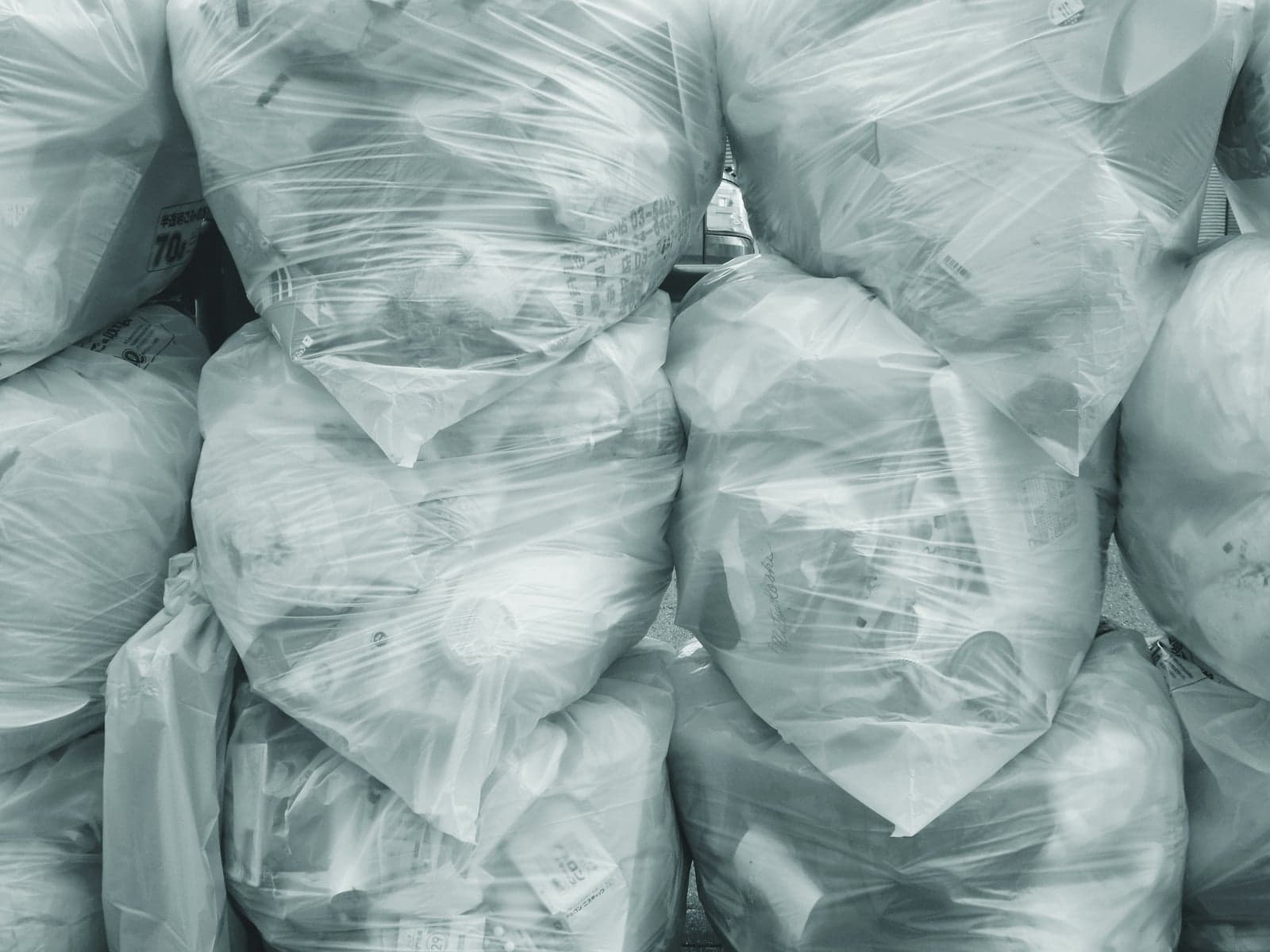 Stacked bags of commercial waste piled up after a missed pickup