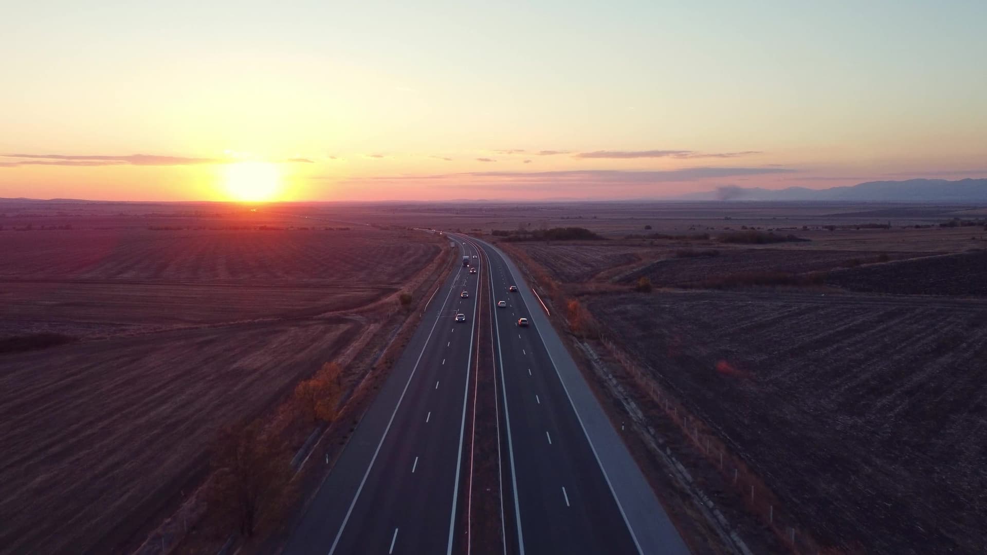 Aerial view of an open highway at sunset symbolizing nationwide waste logistics