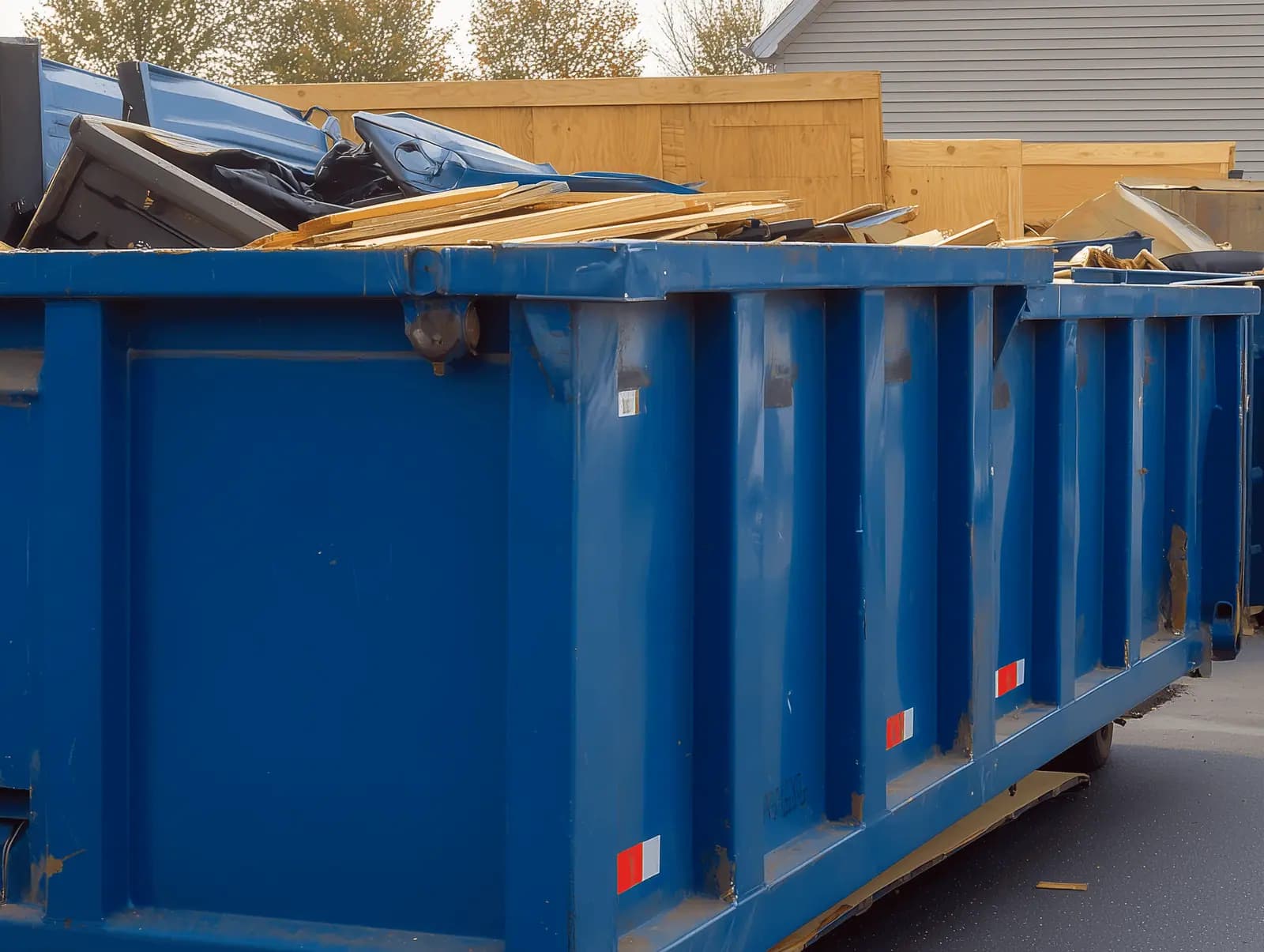 Roll-off dumpsters lined up on site ready for service