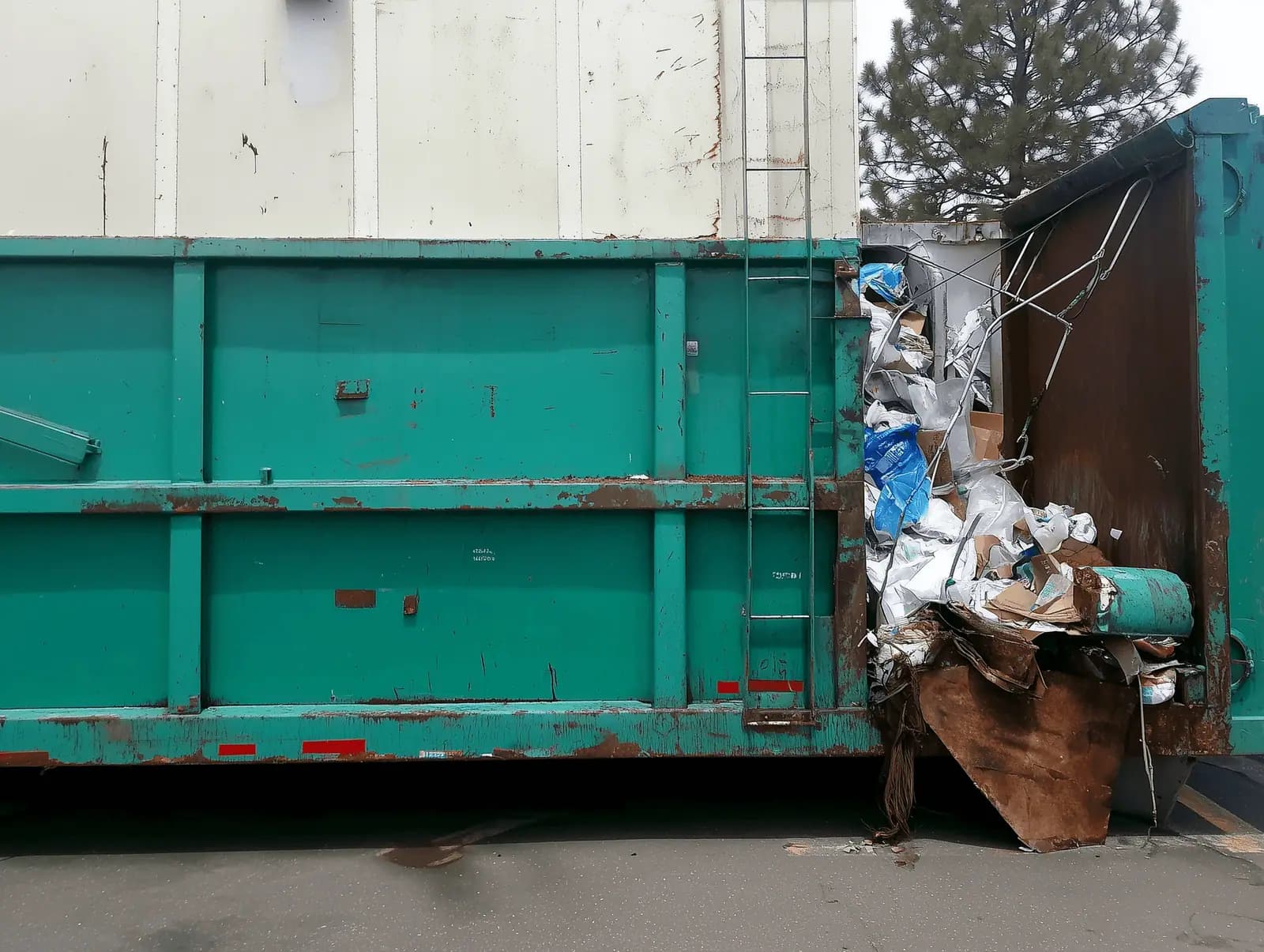 Large green roll-off dumpster sized for high-volume debris